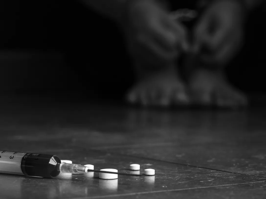 Scattered pills on a dark surface