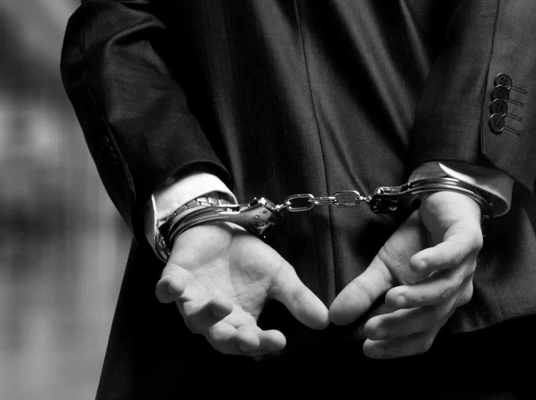 Person with hands in handcuffs