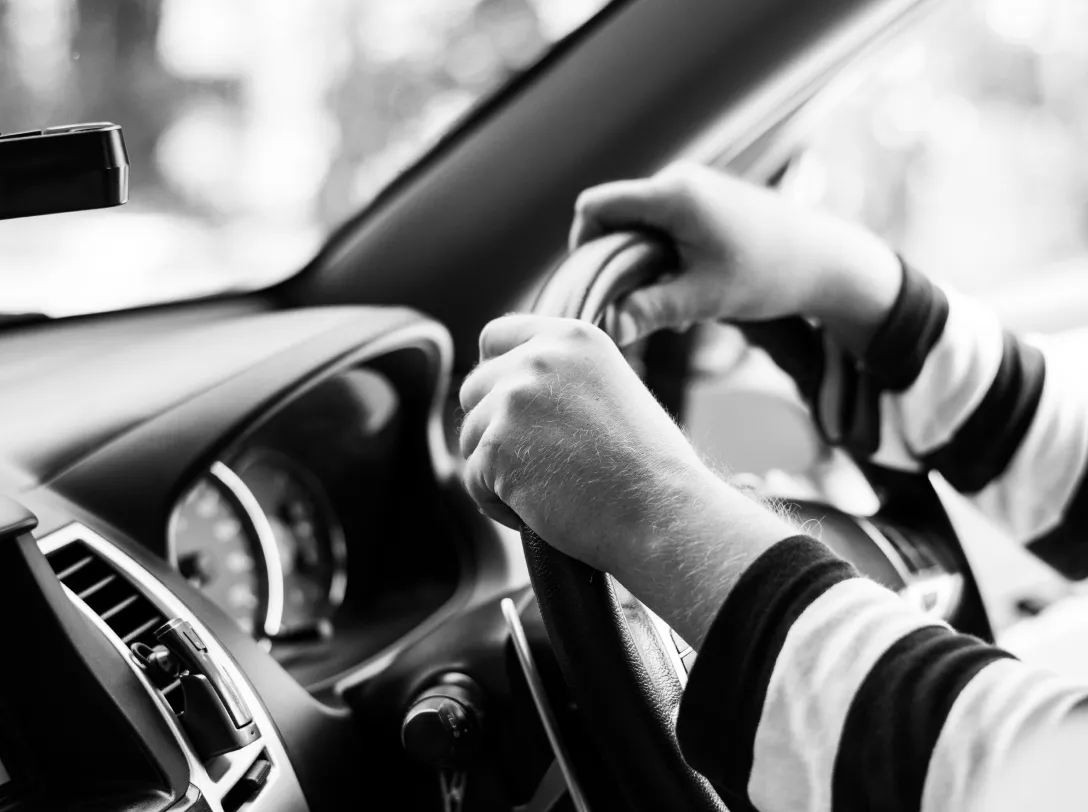 Driver holding a steering wheel